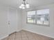 Inviting living room with tile flooring, large window, and modern light fixture at 9013 Tree Valley Cir, Tampa, FL 33615