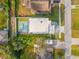 An aerial view of the property showcases the pool, patio, modern landscaping, and the surrounding neighborhood at 910 W West St, Tampa, FL 33602