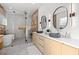 Modern bathroom with dual sinks, stone floors, luxury shower and freestanding bathtub at 910 W West St, Tampa, FL 33602