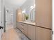 Bright bathroom featuring a double vanity with modern wood cabinetry and a tile backsplash at 910 W West St, Tampa, FL 33602