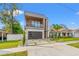 Eye-catching modern home boasting clean lines, a balcony, and a well-maintained lawn at 910 W West St, Tampa, FL 33602