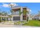 Beautiful modern home with a balcony, wood accents, manicured landscaping and modern driveway at 910 W West St, Tampa, FL 33602