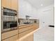 Modern kitchen with stainless steel appliances, custom cabinetry, and marble countertops at 910 W West St, Tampa, FL 33602