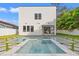 Modern backyard pool and spa with grass pavers and stylish outdoor seating area, ideal for entertaining guests at 910 W West St, Tampa, FL 33602