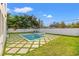 Backyard with a pristine pool, spa, and grass pavers, providing a delightful outdoor experience at 910 W West St, Tampa, FL 33602