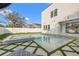 Beautiful backyard featuring a modern pool, spa, and lush green grass, offering a serene outdoor escape at 910 W West St, Tampa, FL 33602