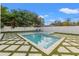 Serene pool and spa area with a private fence, grass pavers, and relaxing lounge space, perfect for unwinding at 910 W West St, Tampa, FL 33602