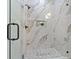 A modern walk-in shower boasts marble-style tiling, glass enclosure, and matte black fixtures at 910 W West St, Tampa, FL 33602