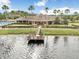 Community clubhouse with a pier overlooking the lake and lush landscaping at 9142 Lake Chase Island Way, Tampa, FL 33626