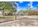 Gated entrance to Lake Chase community with brick sign and well-maintained landscaping at 9142 Lake Chase Island Way, Tampa, FL 33626