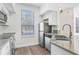 This kitchen features stainless steel appliances, granite countertops, and a view to the outside at 9142 Lake Chase Island Way, Tampa, FL 33626