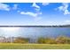 Beautiful lake view with lush green landscaping surrounding the waters edge in Lake Chase Community at 9142 Lake Chase Island Way # 9142, Tampa, FL 33626