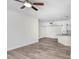 Living room with neutral paint, wood-look floors and an open floorplan at 9142 Lake Chase Island Way, Tampa, FL 33626