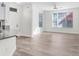 Living room with lots of natural light, neutral paint, and wood-look floors at 9142 Lake Chase Island Way, Tampa, FL 33626