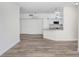 Living room with neutral paint, wood-look floors and an open floorplan at 9142 Lake Chase Island Way, Tampa, FL 33626