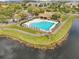 A sparkling community pool with a cabana and plenty of lounge space by the lake at 9142 Lake Chase Island Way, Tampa, FL 33626