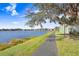 Picturesque walking path beside the lake, lined with trees and offering a serene view in Lake Chase at 9142 Lake Chase Island Way, Tampa, FL 33626