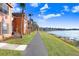 Scenic view of the walking path along the lake with colorful homes in the Lake Chase Community at 9142 Lake Chase Island Way, Tampa, FL 33626