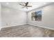 Neutral bedroom has hardwood floors and a window that provides natural light at 10063 Celtic Ash Dr, Ruskin, FL 33573