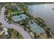 Aerial view of community tennis and basketball courts, a pool and a lake in a residential neighborhood at 10063 Celtic Ash Dr, Ruskin, FL 33573