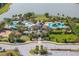 Aerial view showcasing the community pool and clubhouse with landscaping at 10063 Celtic Ash Dr, Ruskin, FL 33573