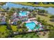 Aerial view showcasing the community pool and clubhouse with landscaping at 10063 Celtic Ash Dr, Ruskin, FL 33573