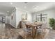 Stylish dining room with modern decor, hard floors, modern table setting, and lots of natural light at 10063 Celtic Ash Dr, Ruskin, FL 33573