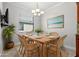 Cozy dining room includes a wooden table with seating for six and stylish light fixture at 10063 Celtic Ash Dr, Ruskin, FL 33573