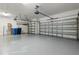 Spacious garage with two garage doors and epoxy flooring at 10063 Celtic Ash Dr, Ruskin, FL 33573