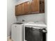 Laundry room features a washer, dryer, and wooden cabinets for storage at 10063 Celtic Ash Dr, Ruskin, FL 33573