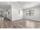 Bright living room features wood-look flooring, recessed lighting, and neutral wall paint at 10063 Celtic Ash Dr, Ruskin, FL 33573