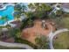 Aerial shot of a community playground with swings and slides, near the community pool at 10063 Celtic Ash Dr, Ruskin, FL 33573