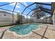 Screened-in pool with brick patio in backyard, providing a serene outdoor space at 10063 Celtic Ash Dr, Ruskin, FL 33573