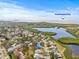 Aerial view of neighborhood near Fred Howard Park with waterfront access and lush greenery at 1007 Lake Avoca Dr, Tarpon Springs, FL 34689