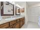 Bright bathroom featuring double sinks, granite countertops, tile floors and neutral walls at 1007 Lake Avoca Dr, Tarpon Springs, FL 34689