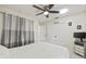 Bedroom featuring ceiling fan, white walls, curtains and large storage closet at 1007 Lake Avoca Dr, Tarpon Springs, FL 34689