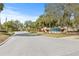 Pointe Alexis community entrance sign surrounded by mature landscaping as you enter into the neighborhood at 1007 Lake Avoca Dr, Tarpon Springs, FL 34689