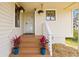 Welcoming front porch with flower boxes, decorative plants and a white trimmed railing at 1007 Lake Avoca Dr, Tarpon Springs, FL 34689