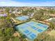 Aerial view of well-maintained community tennis courts, perfect for recreation at 1007 Lake Avoca Dr, Tarpon Springs, FL 34689