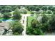 An aerial view of lush landscaping and a tennis court at 102 Brent Cir, Oldsmar, FL 34677