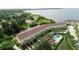 Scenic aerial view of waterfront townhomes with a pool and canal access, surrounded by lush greenery at 102 Brent Cir, Oldsmar, FL 34677