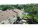 Aerial view of townhomes with lush landscaping and a tennis court at 102 Brent Cir, Oldsmar, FL 34677