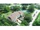 Aerial view of townhomes with lush landscaping and a tennis court at 102 Brent Cir, Oldsmar, FL 34677