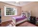 Comfortable bedroom with a ceiling fan, plantation shutters, and hardwood floors at 102 Brent Cir, Oldsmar, FL 34677