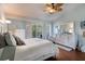 Comfortable bedroom with wood floors, a ceiling fan, and a private balcony at 102 Brent Cir, Oldsmar, FL 34677