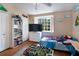 bedroom featuring hardwood floors, a ceiling fan, and ample natural light from the window at 102 Brent Cir, Oldsmar, FL 34677