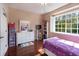 Bright bedroom with a ceiling fan, plantation shutters, and hardwood floors at 102 Brent Cir, Oldsmar, FL 34677