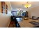 Cozy dining area with wood floors, a decorative chandelier, and a view into the living room at 102 Brent Cir, Oldsmar, FL 34677