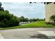 Condo with a dock along the water with lush green lawn and trees on a sunny day at 102 Brent Cir, Oldsmar, FL 34677