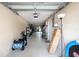 Long garage featuring overhead storage, an exterior door, and ample space for parking and projects at 102 Brent Cir, Oldsmar, FL 34677